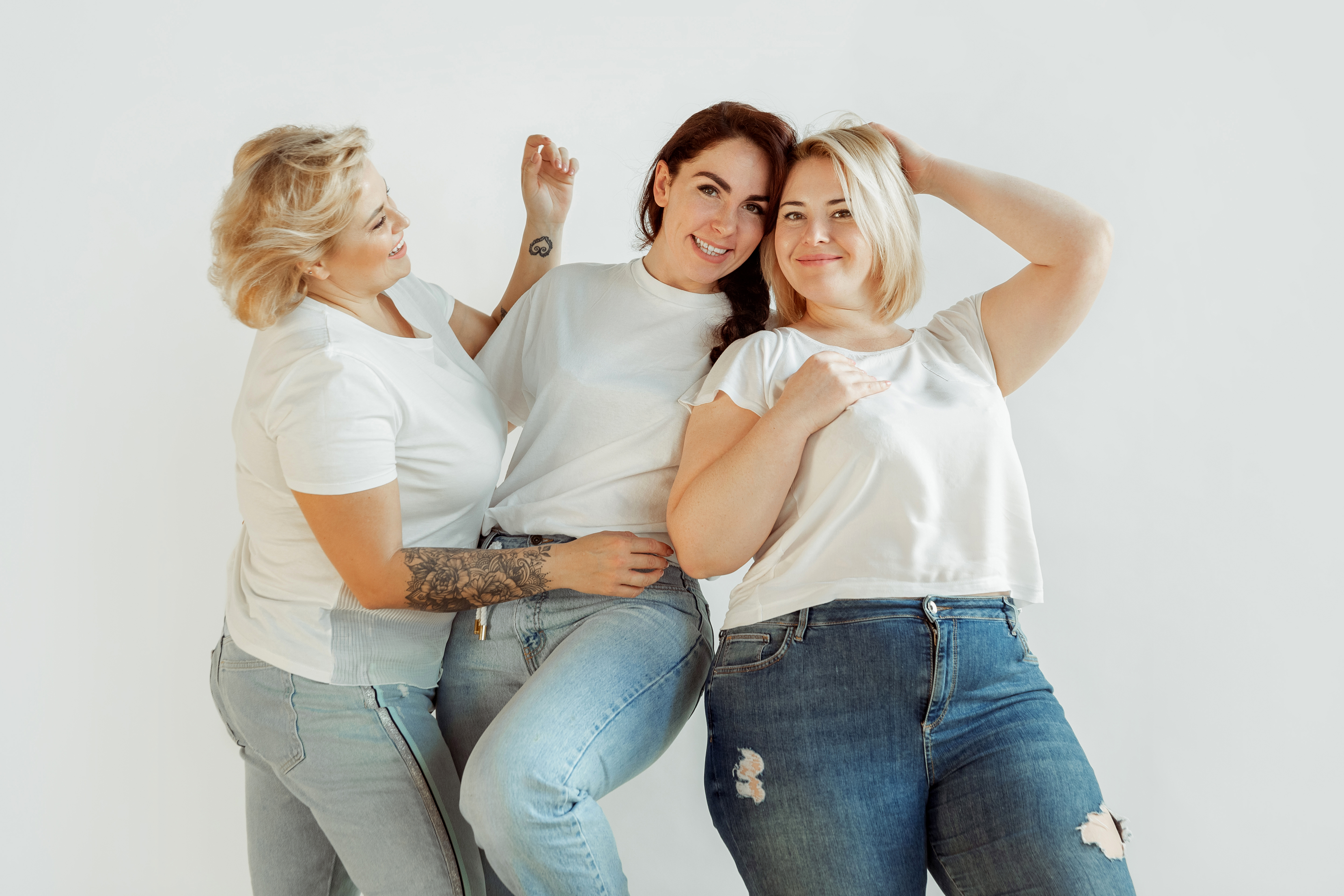 Confidence. Young caucasian women in casual clothes having fun together. Friends posing on white background, laughting, looks happy, well-kept. Bodypositive, feminism, loving themself, beauty concept., Confidence. Young caucasian women in casual clothes having fun together. Friends posing on white background, laughting, looks happy, well-kept. Bodypositive, feminism, loving themself, beauty concept.